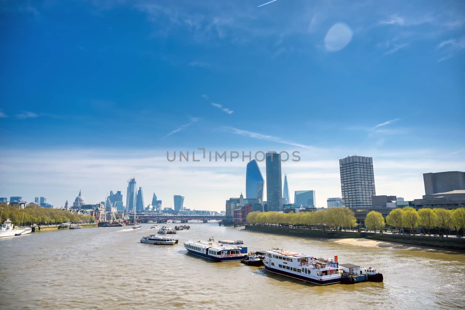 A view along the River Thames on a sunny day in London, UK.