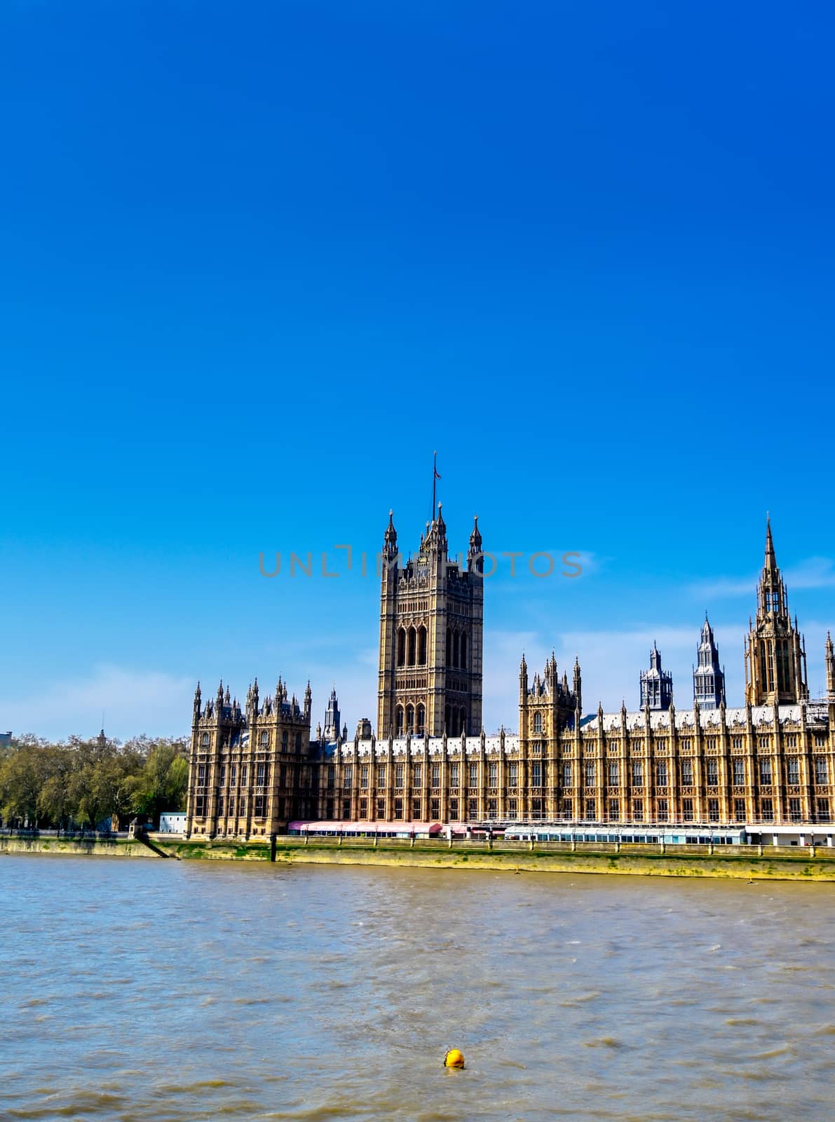 British Parliament along the River Thames on a sunny day in London, UK.