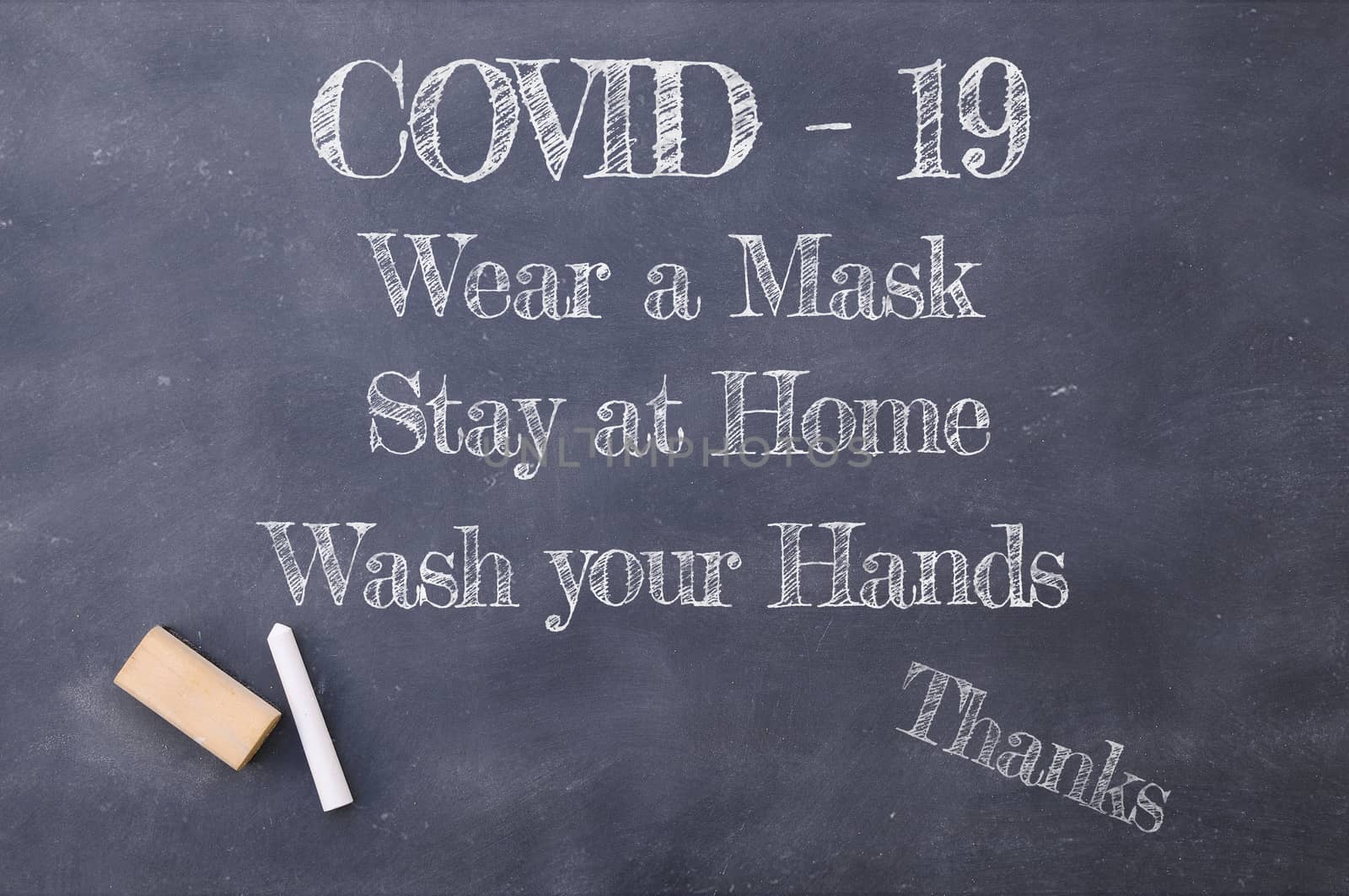 Coronavirus pandemic behaviour rules or health advice. Covid-19 wear a mask, Stay at Home and wash your hands chalkboard inscription.