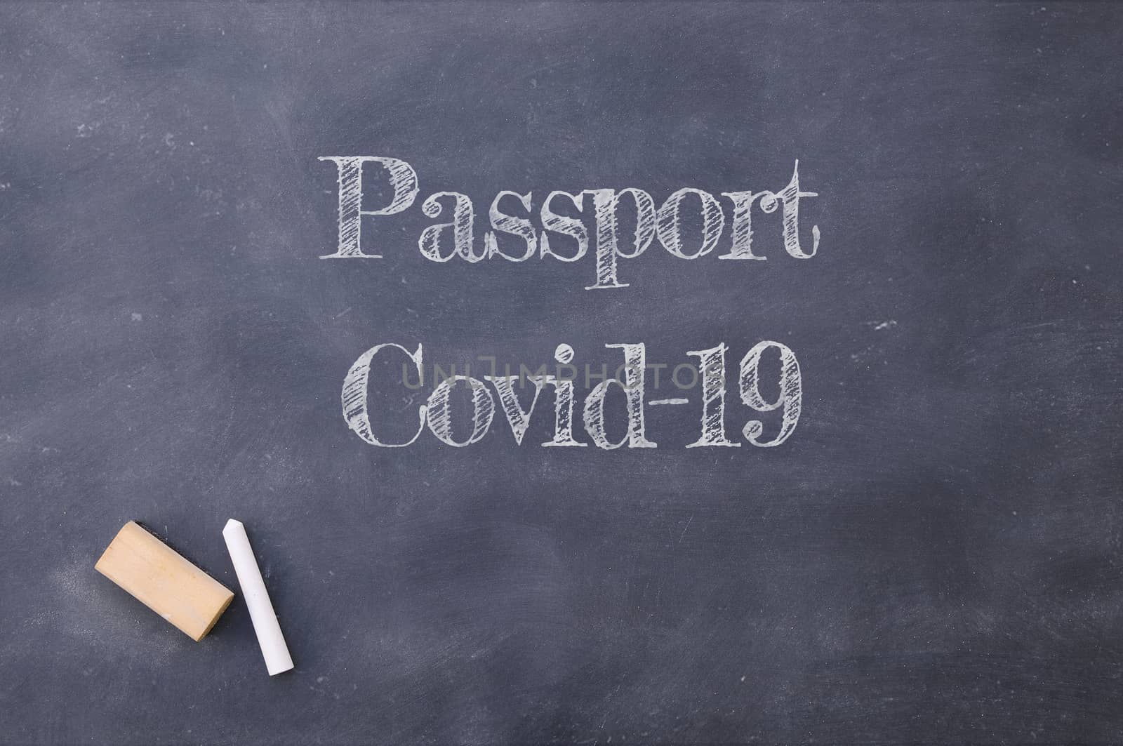 Passport Covid-19 written on a school blackboard.