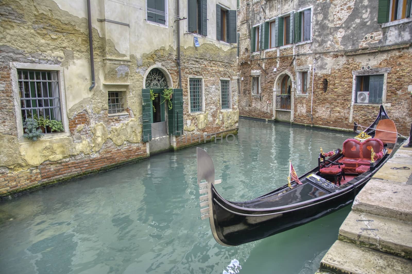 Gondola sailing through a canal in Venice, Italy.