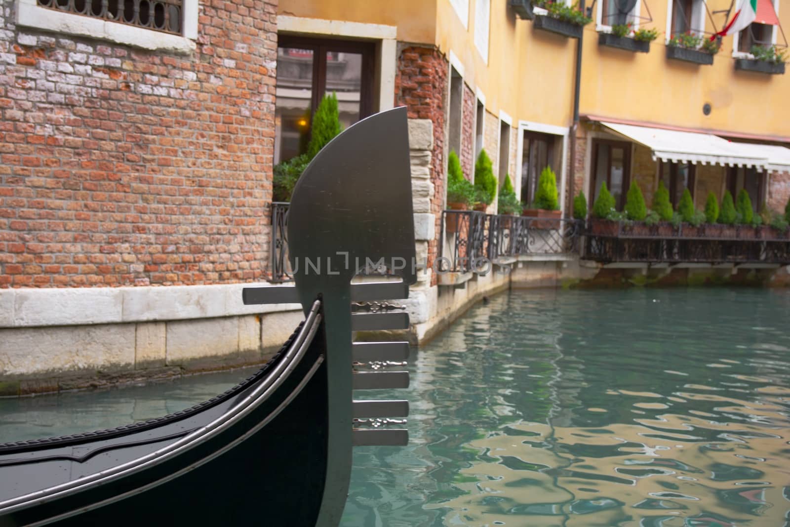 Gondola sailing through a canal in Venice, Italy.