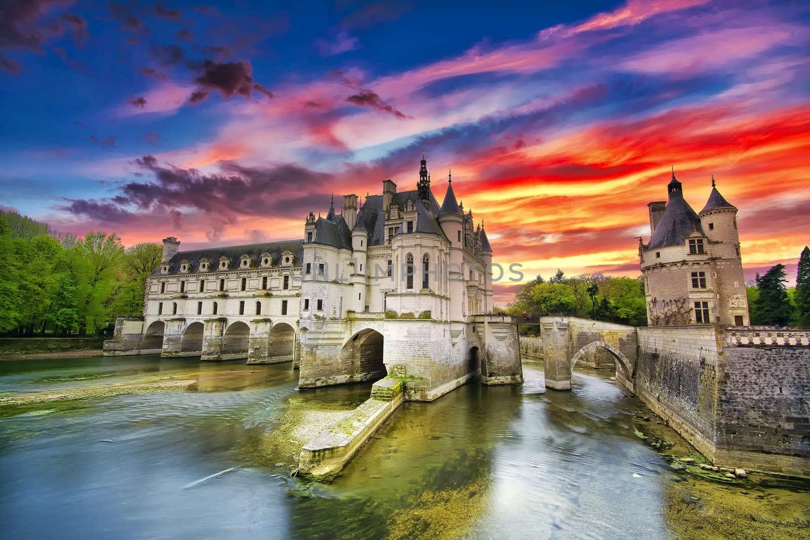 Chenonceau, France - April 16, 2019: Medieval castle in Chenonceaux, France. Beautiful Chateau de Chenonceau at dusk over the river Cher, Loire Valley, France.