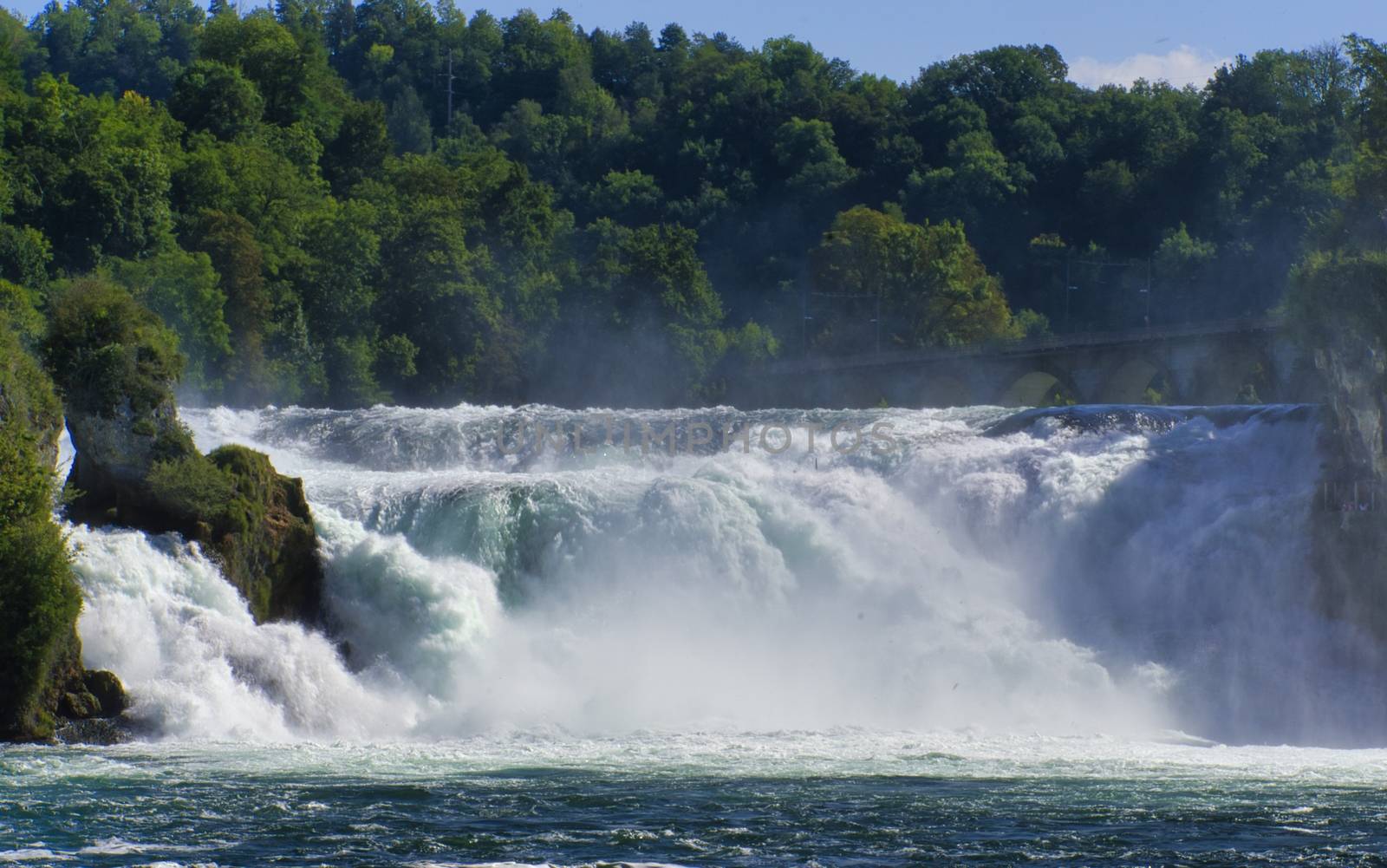 the famous rhine falls in the swiss near the city of Schaffhausen - sunny day and blue sky