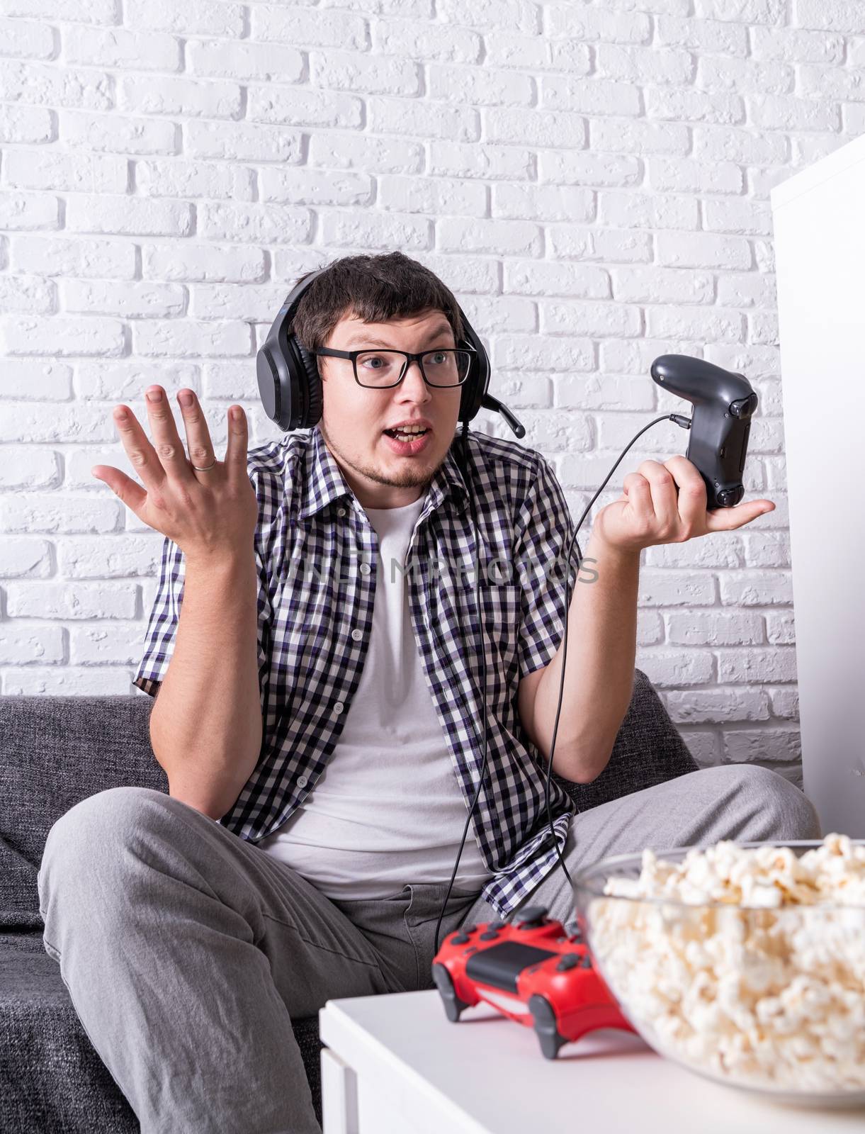 Stay home. Disappointed young man playing video games at home