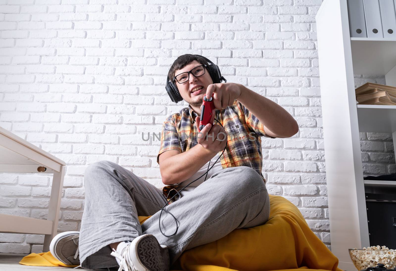 Stay home. Excited young man playing video games at home