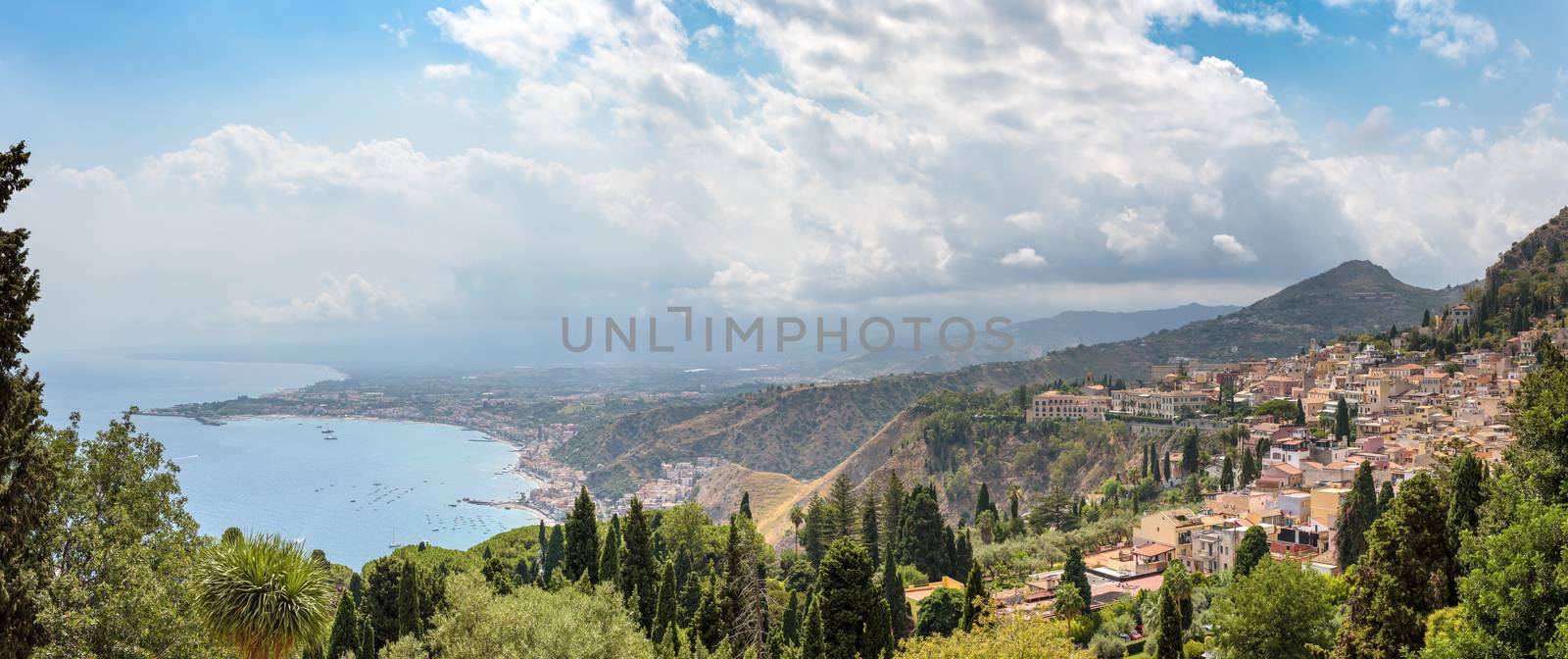 Panoramic view of Taormina with Giardini Naxox town in the backgroind, Sicily, Italy