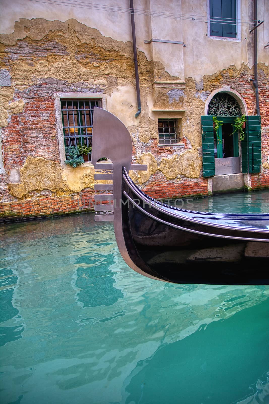 Gondola sailing through a canal in Venice. by CreativePhotoSpain