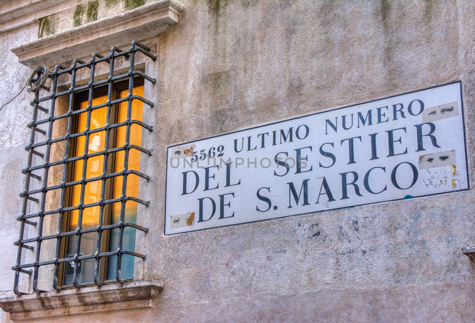 Venice, Italy - October 13, 2019: Road sign with text 5562 Ultimo numero del Sestier de San Marco in italian language.