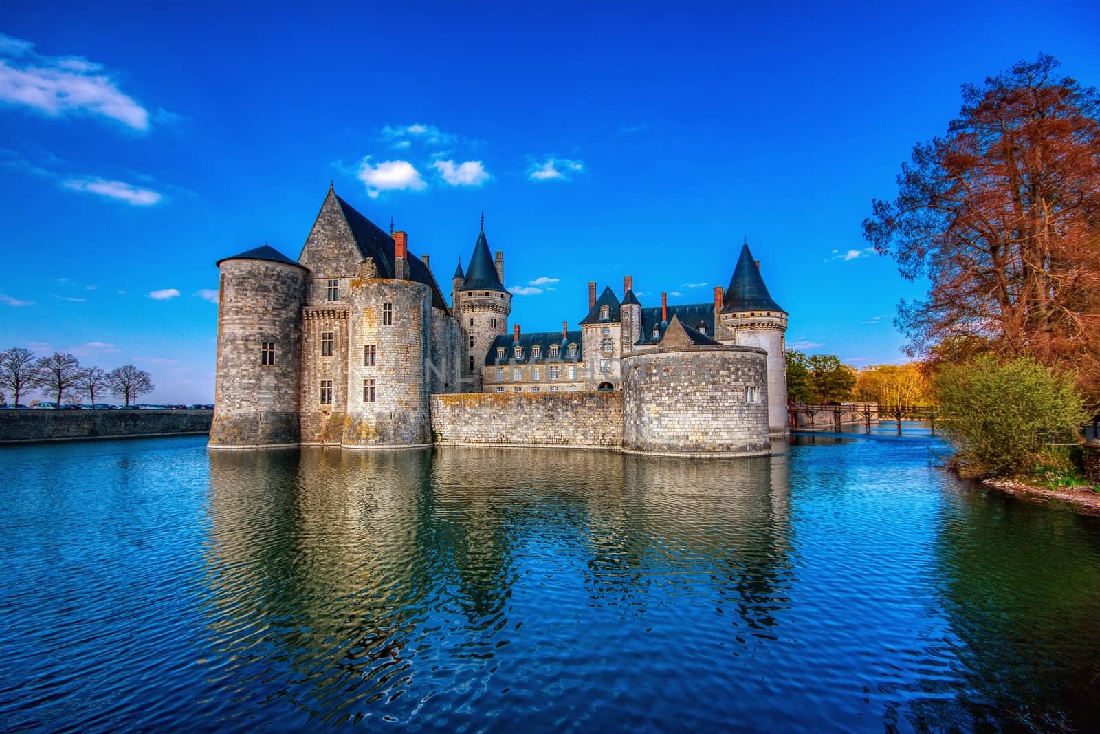 Sully Sur Loire, France - April 13, 2019: Famous medieval castle Sully sur Loire at sunset, Loire valley, France. The chateau Sully sur Loire dates from the end of the 14th century and is a prime example of medieval fortress.