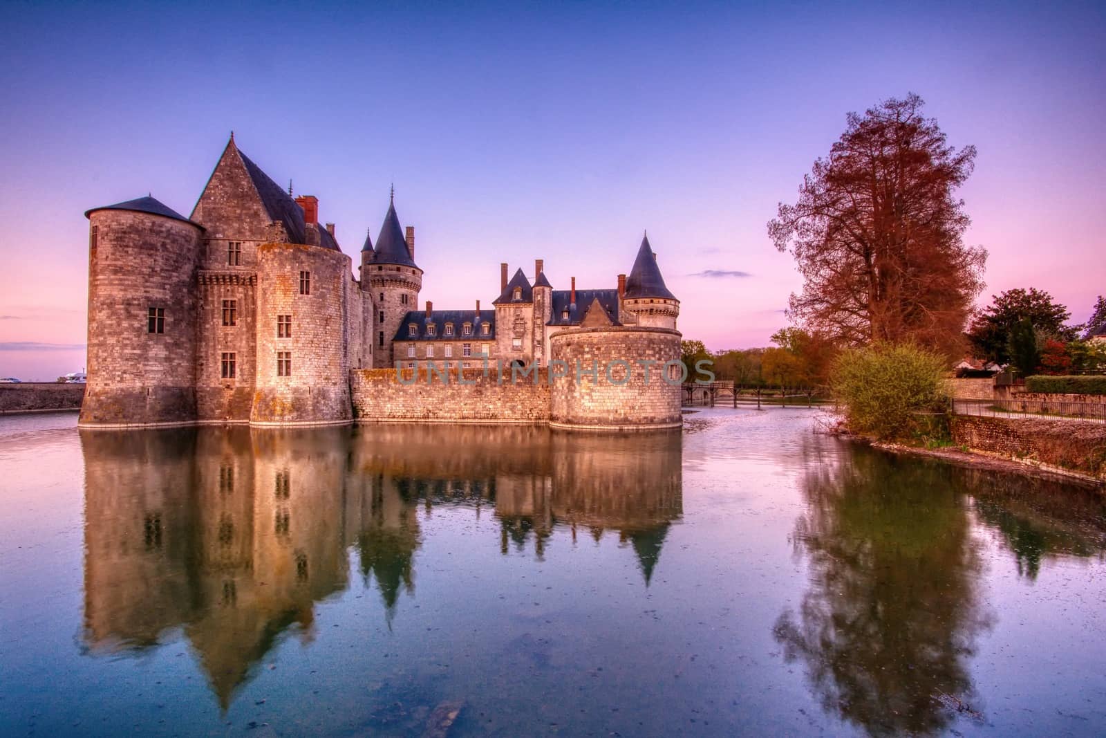 Sully Sur Loire, France - April 13, 2019: Famous medieval castle Sully sur Loire at sunrise, Loire valley, France. The chateau of Sully sur Loire dates from the end of the 14th century and is a prime example of medieval fortress.