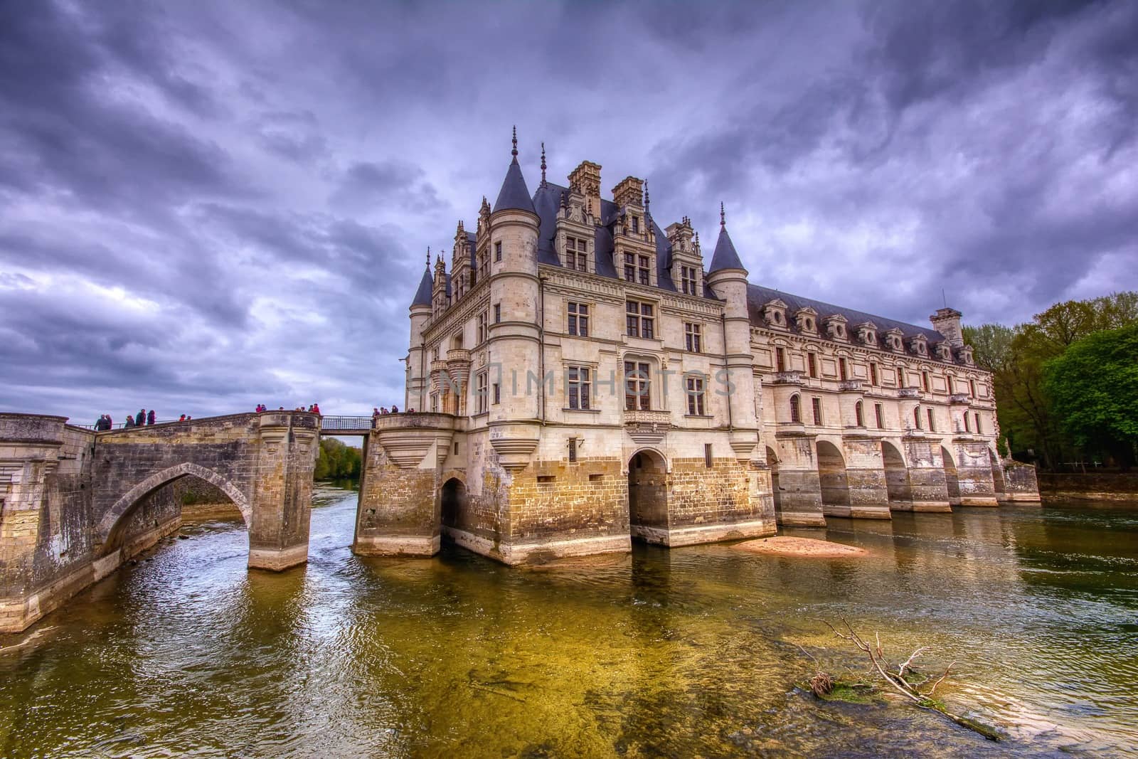 Chenonceau, France - April 16, 2019: Medieval castle in Chenonceaux, France. Beautiful Chateau de Chenonceau at dusk over the river Cher, Loire Valley, France.