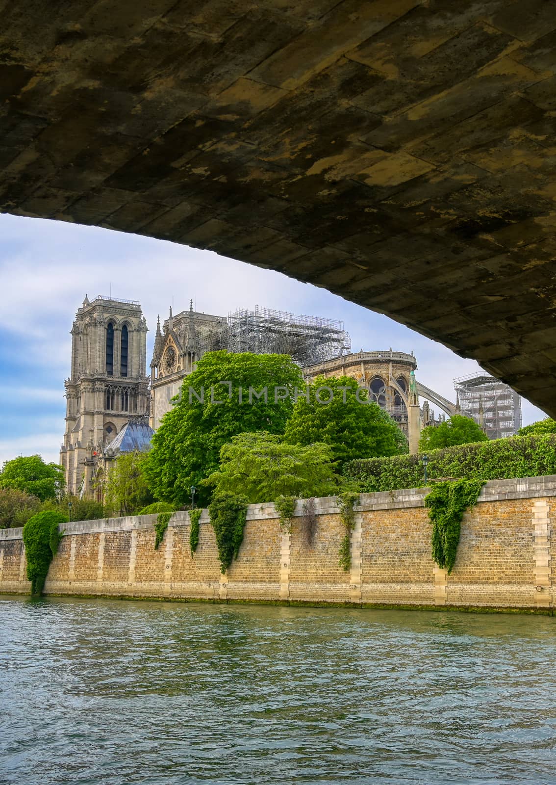 Paris, France - April 21, 2019 - Notre Dame Cathedral on the Seine River in Paris, France after the fire on April 15, 2019.