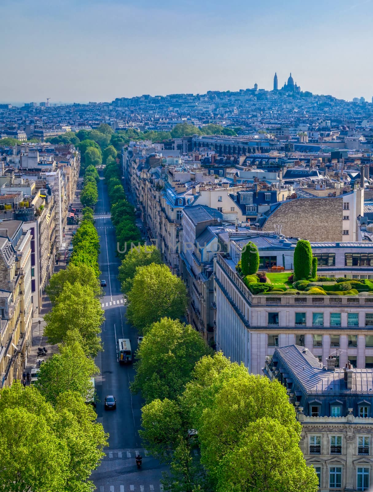 A view of Paris, France from the Arc de Triomphe on a sunny day.