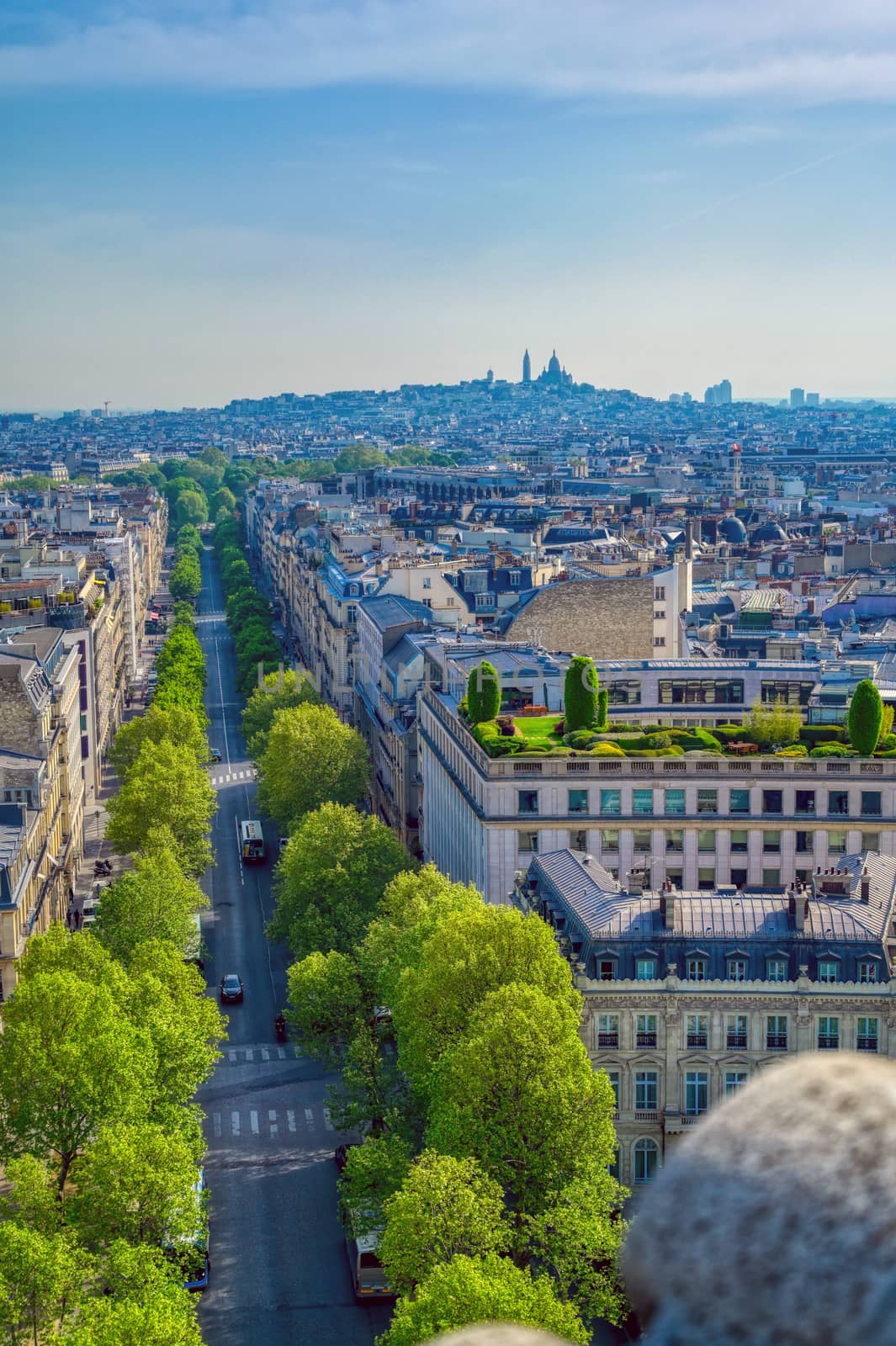 A view of Paris, France from the Arc de Triomphe on a sunny day.