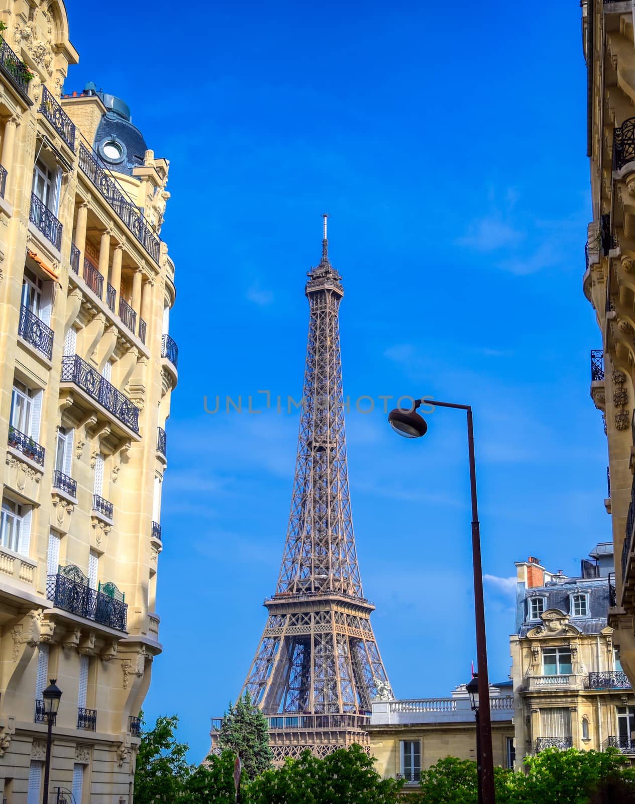 A view of the Eiffel Tower from the streets of Paris, France.