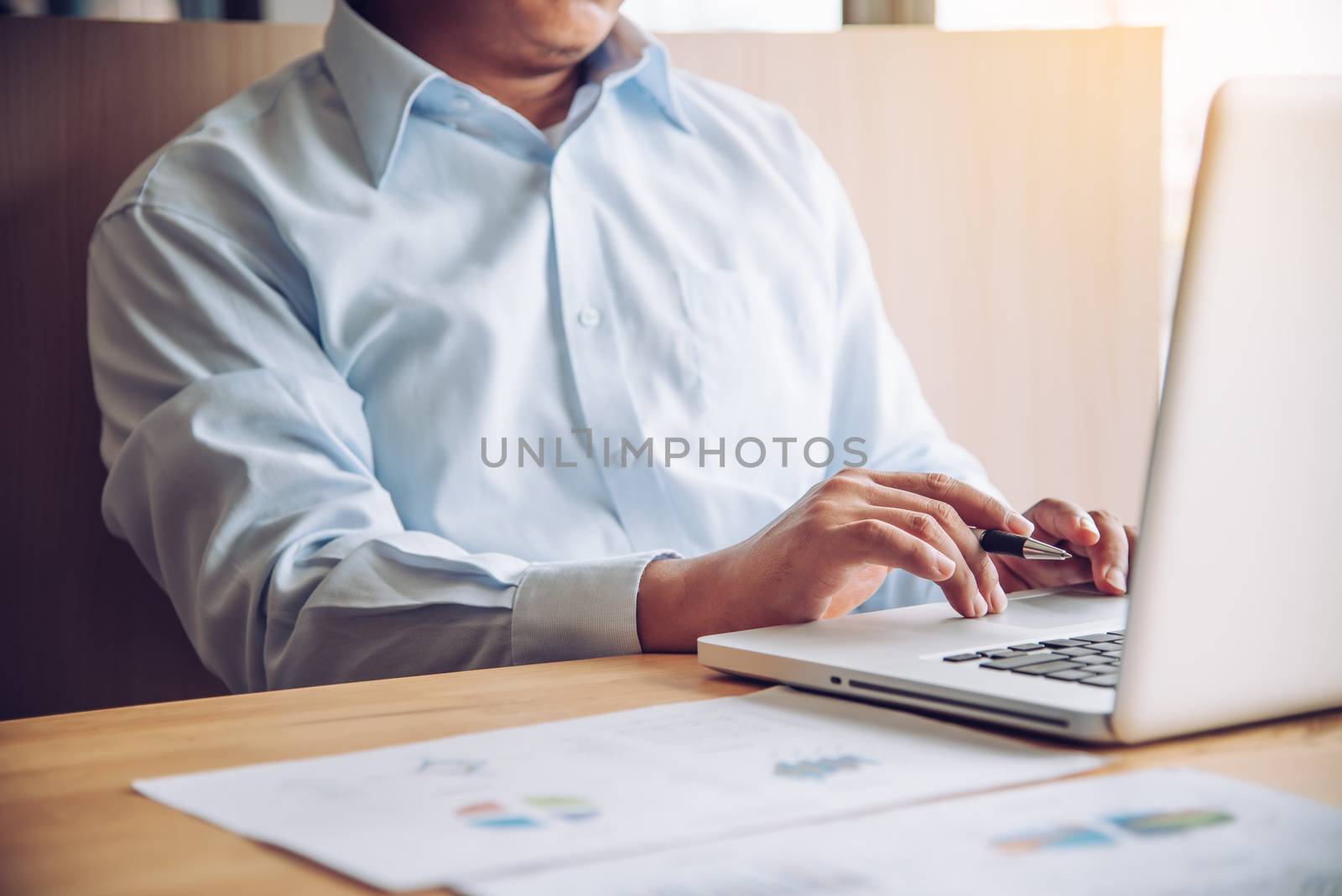 businessman working with laptop in open space office by photobyphotoboy
