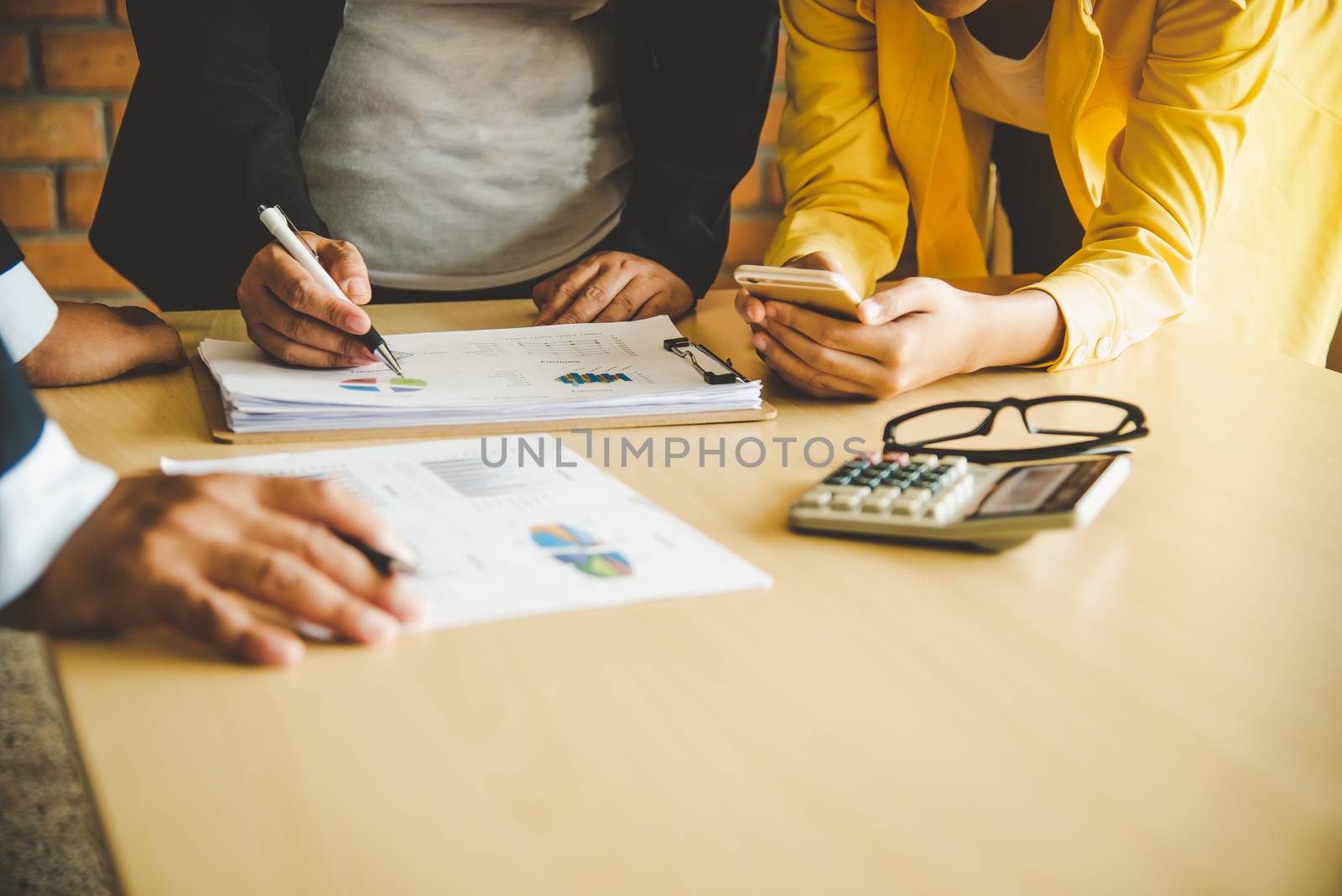 The team is working on accounting documents and team work together to present the work and help solve the problem.