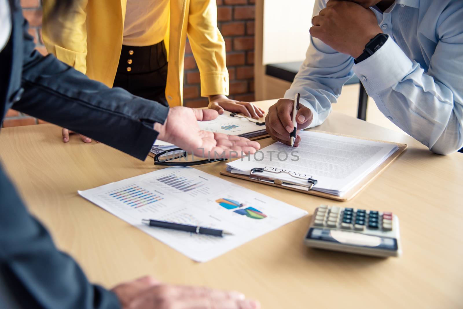 The team is working on accounting documents and team work together to present the work and help solve the problem.