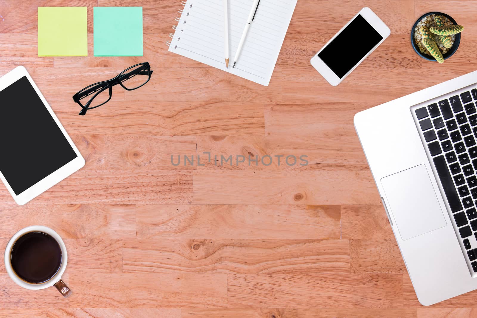 Top view of office desk table. by NuwatPhoto