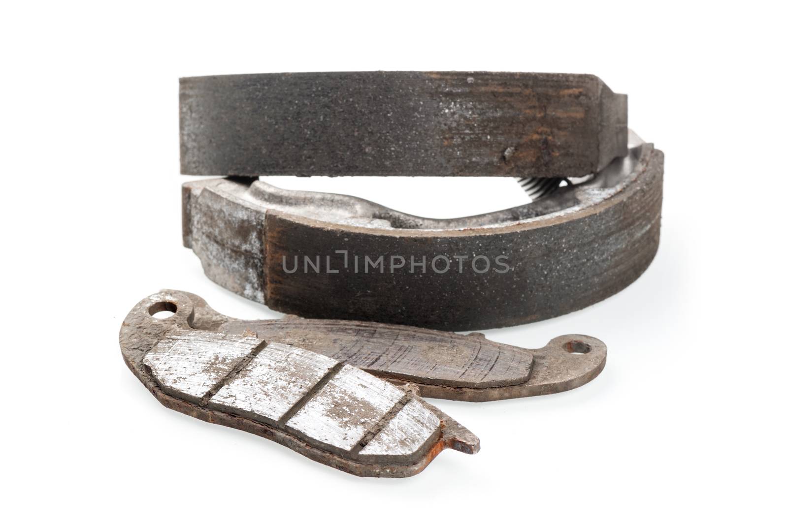 worn motorcycle break pads and break shoes on white background
