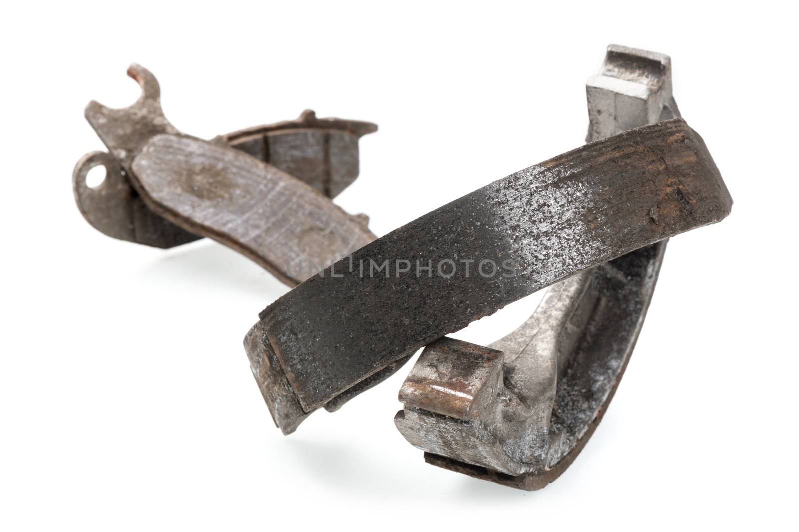 worn motorcycle break pads and break shoes on white background
