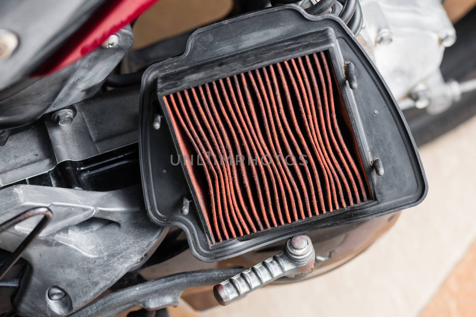 closeup worn motorcycle air filter. Motorcycle maintenance concept.