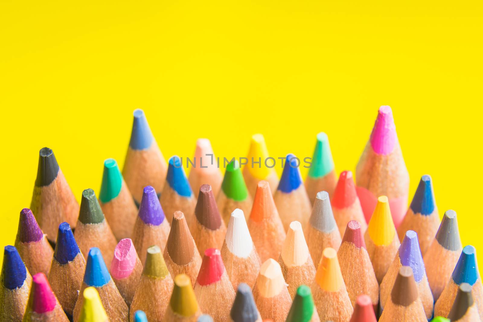 Back to school set multicolored pencils colorful making forms side view on a yellow backround