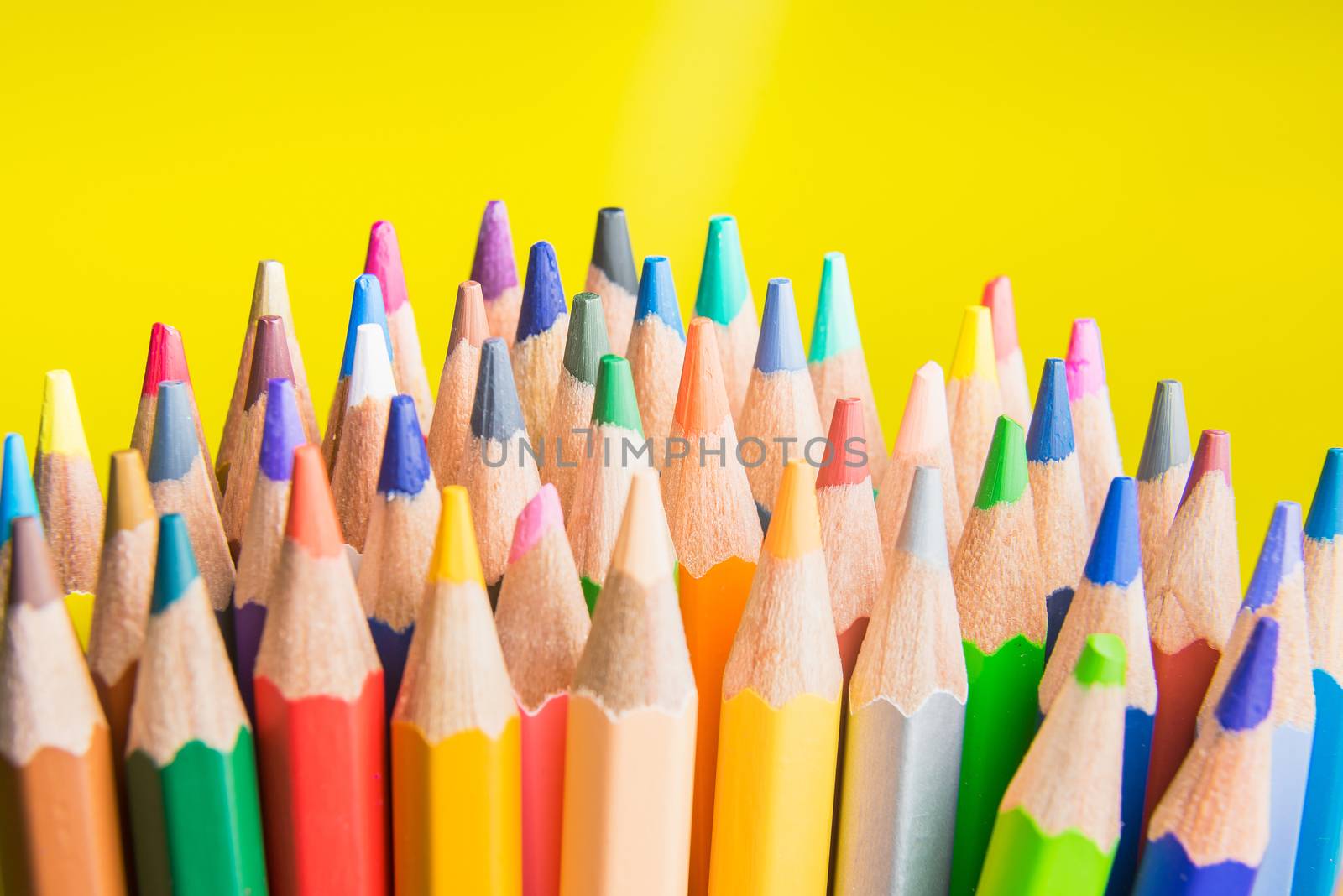 Back to school set multicolored pencils colorful making forms side view on a yellow backround