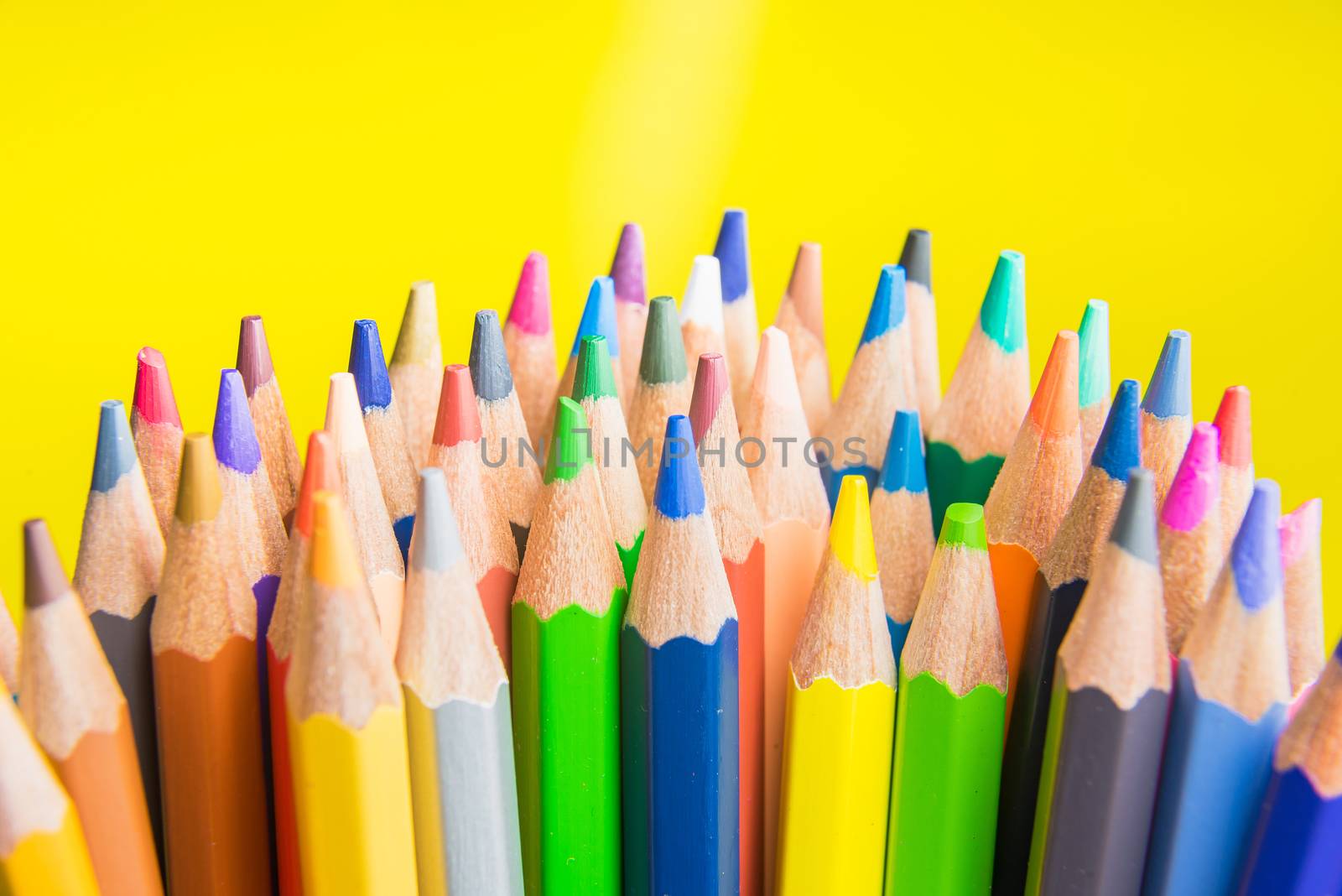Back to school set multicolored pencils colorful making forms side view on a yellow backround