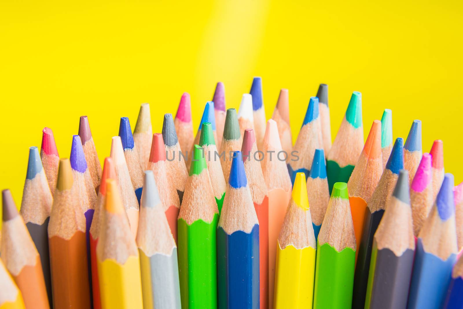 Back to school set multicolored pencils colorful making forms side view on a yellow backround