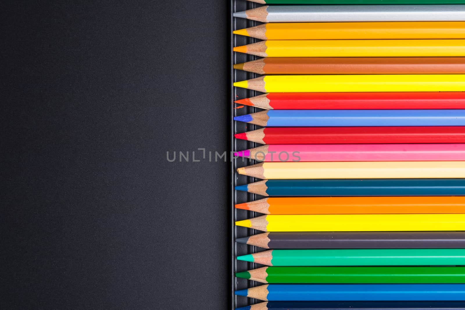 Color Pencils with plastic case isolated on Black Background clo by Bubbers