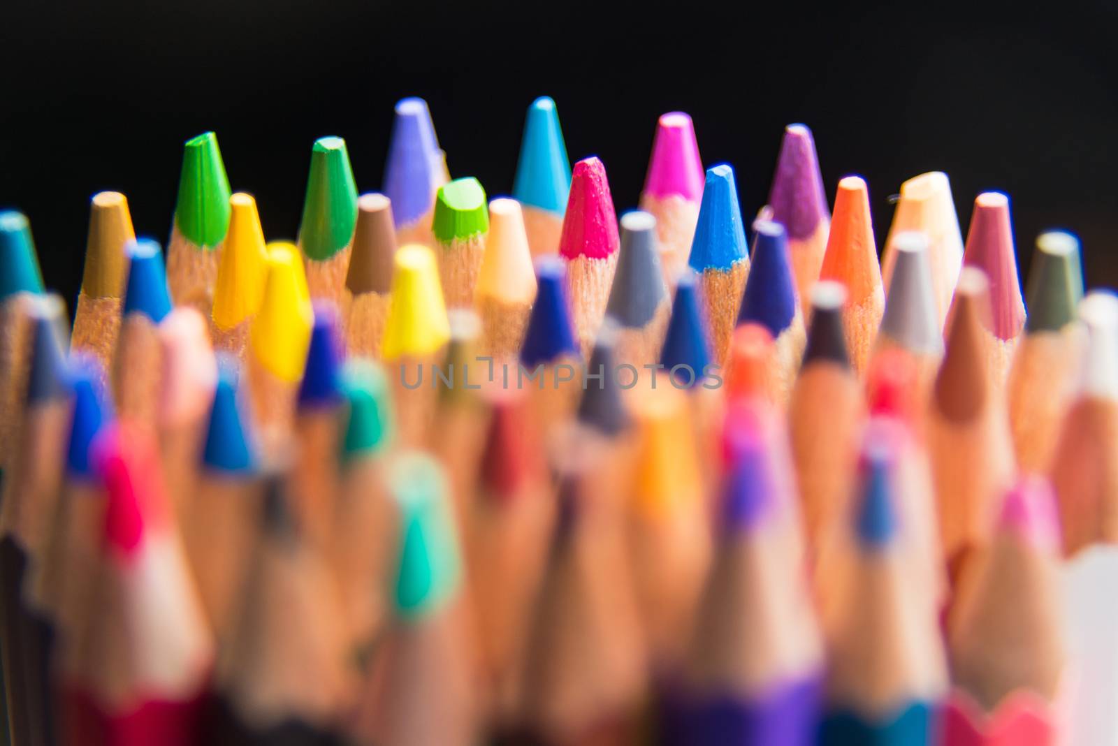 Back to school set multicolored pencils colorful making forms side view on a black backround
