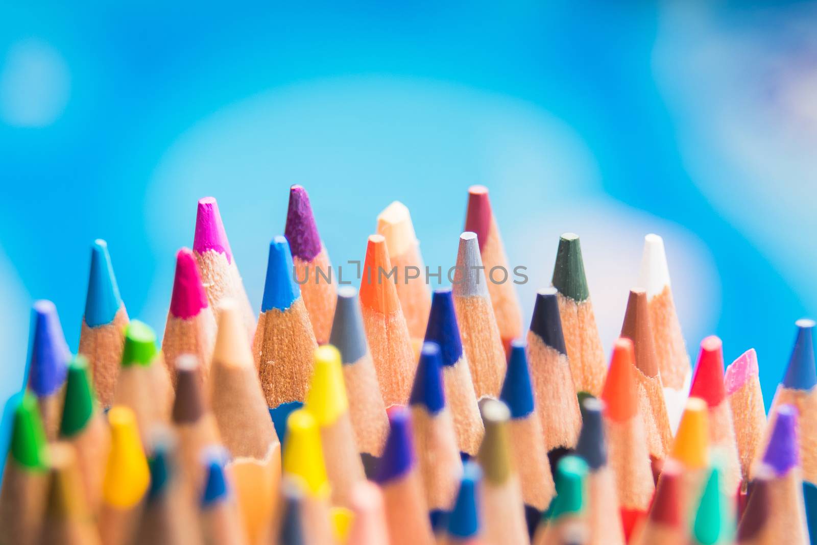 Back to school set multicolored pencils colorful making forms side view on a bule backround