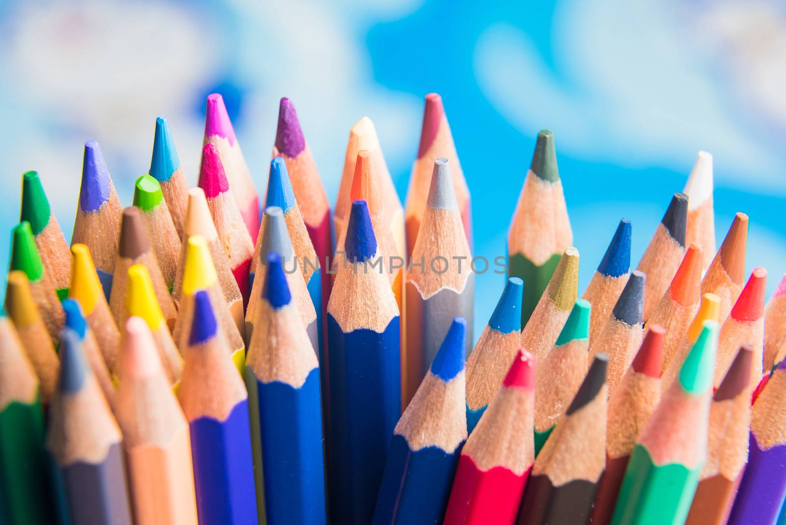 Back to school set multicolored pencils colorful making forms side view on a bule backround