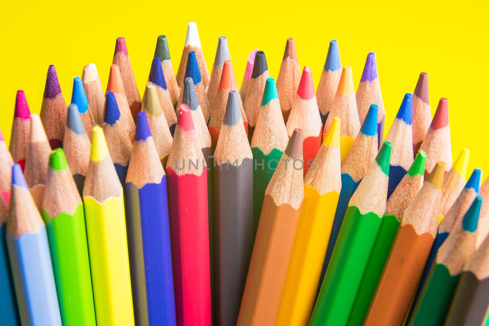 Back to school set multicolored pencils colorful making forms side view on a yellow backround