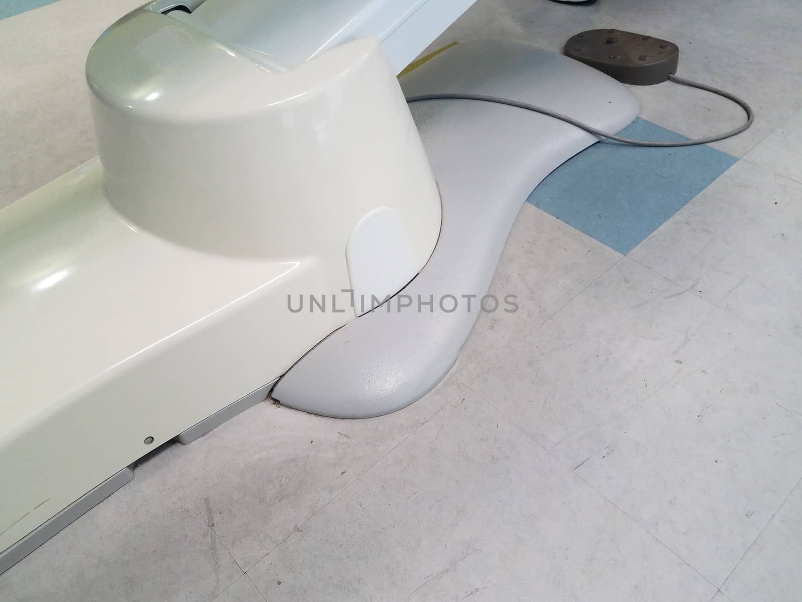 dental chair with electrical cable and tile floor