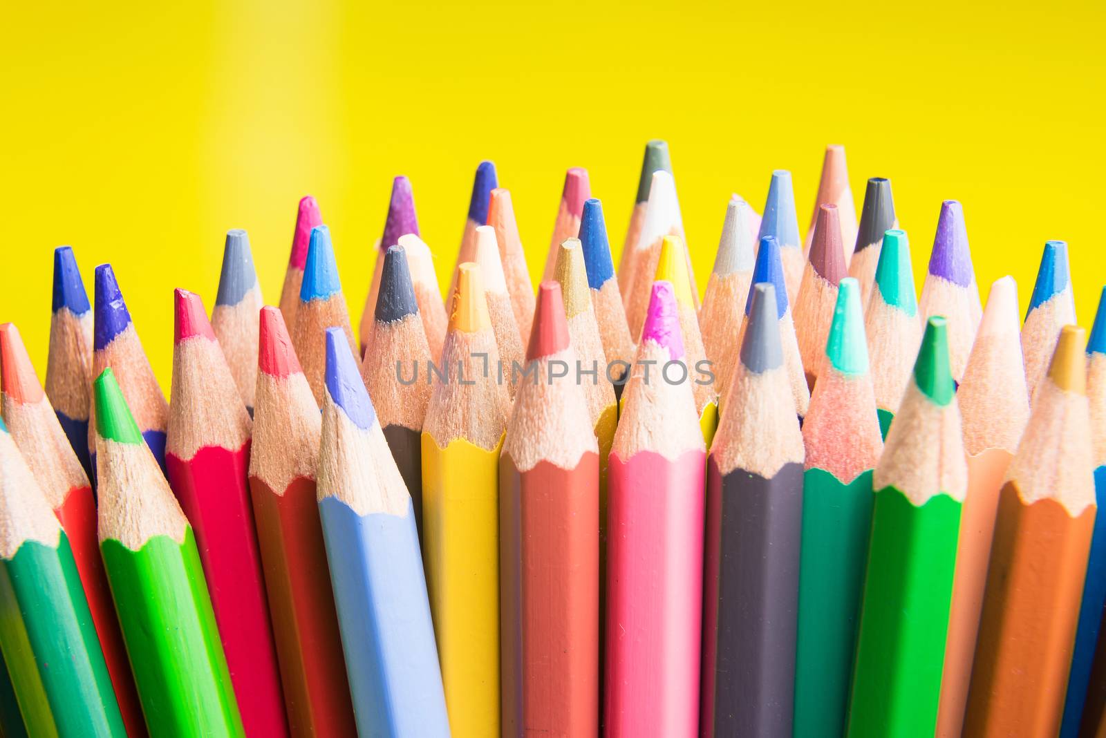 Back to school set multicolored pencils colorful making forms side view on a yellow backround
