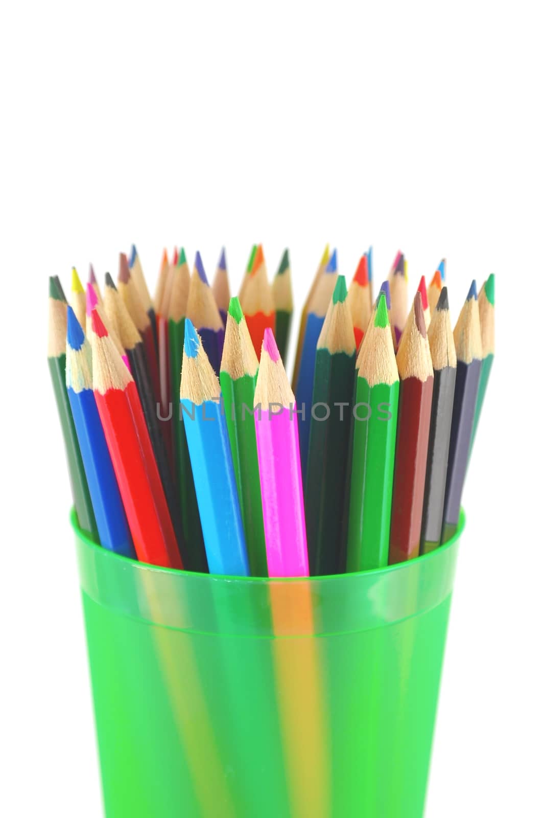 Color pencils in the green prop over white. Shallow DOF.