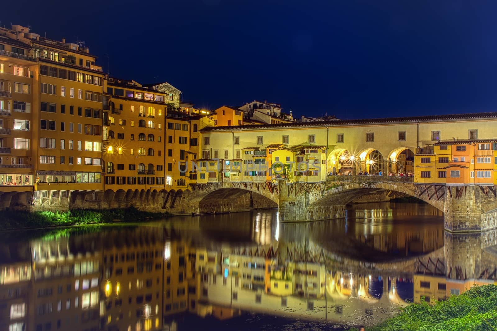 Florence, Italy - June 26, 2018: Ponte Vecchio in Florence, Italy, on a summer night. Thousands of tourists go through the bridge to day .
