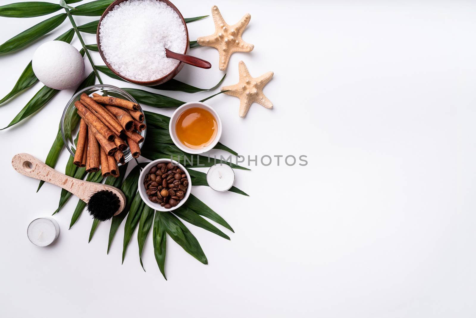 Natural cosmetics or spa setting on palm leaf with copy space by Desperada