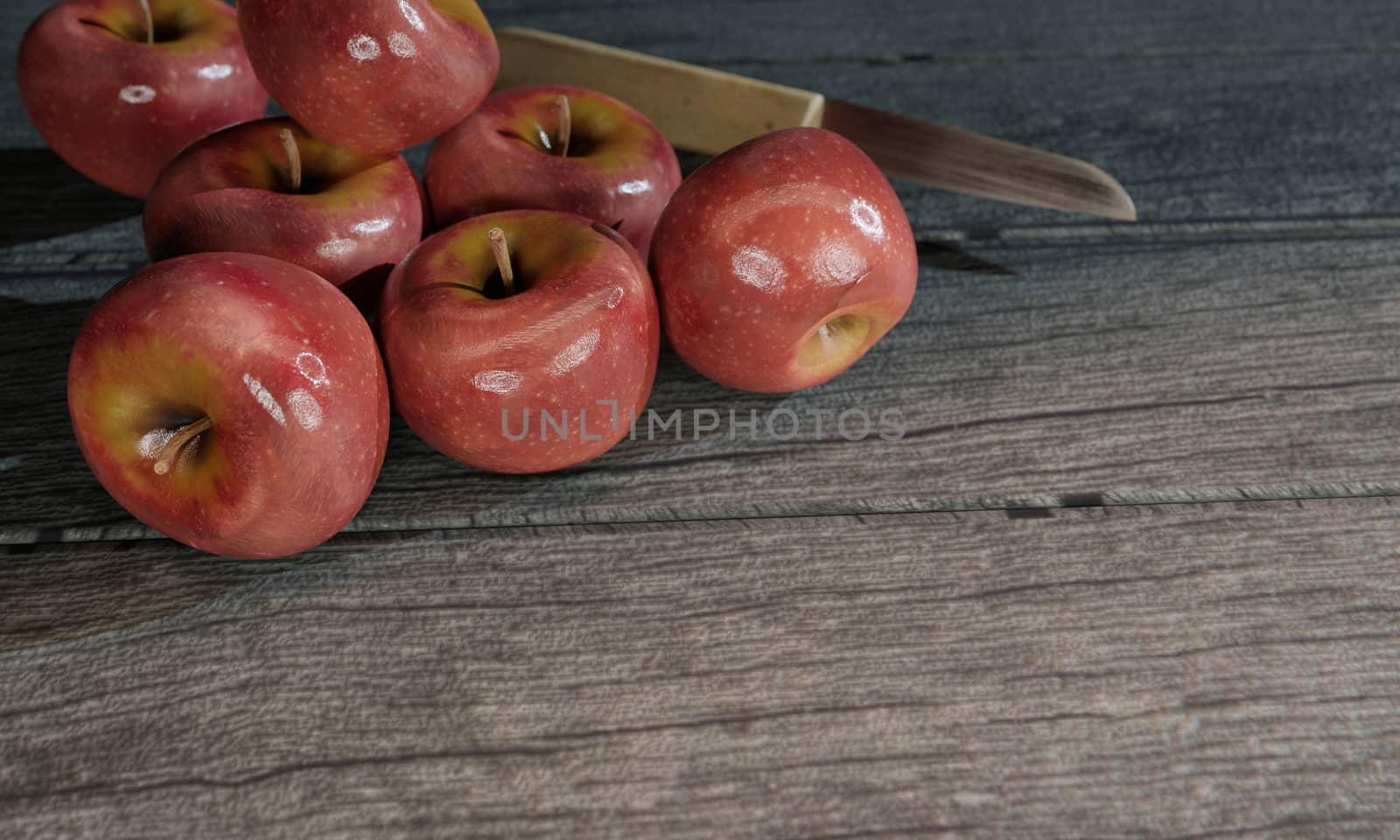 Red apples and blur small knife wood handle on gray wooden by ridersuperone