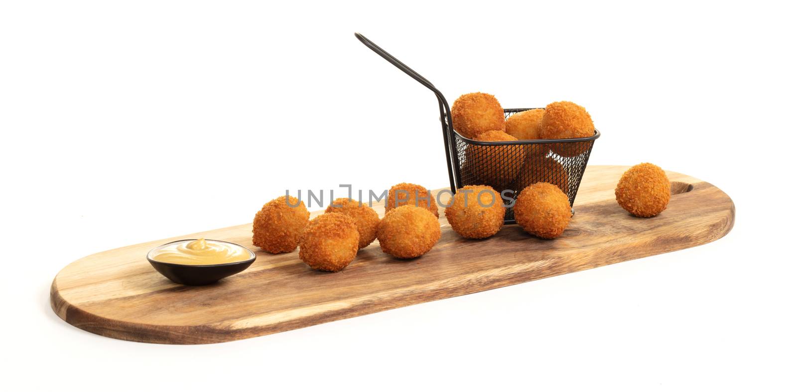 Dutch traditional snack bitterbal on a serving board, isolated