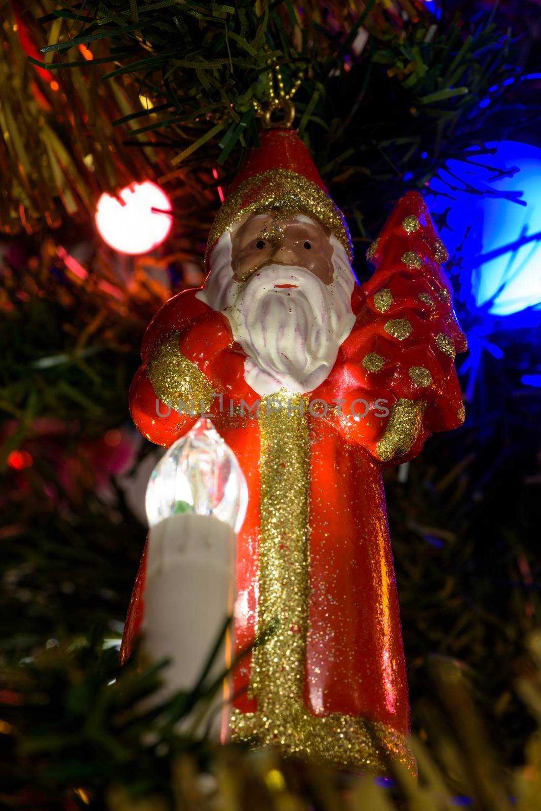 Closeup of Santa Claus figure on a Christmas tree as background