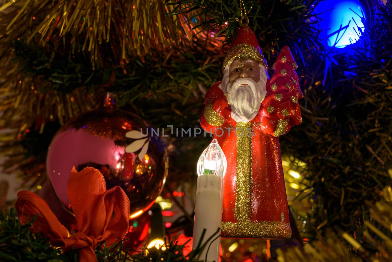 Closeup of Santa Claus figure on a Christmas tree as background