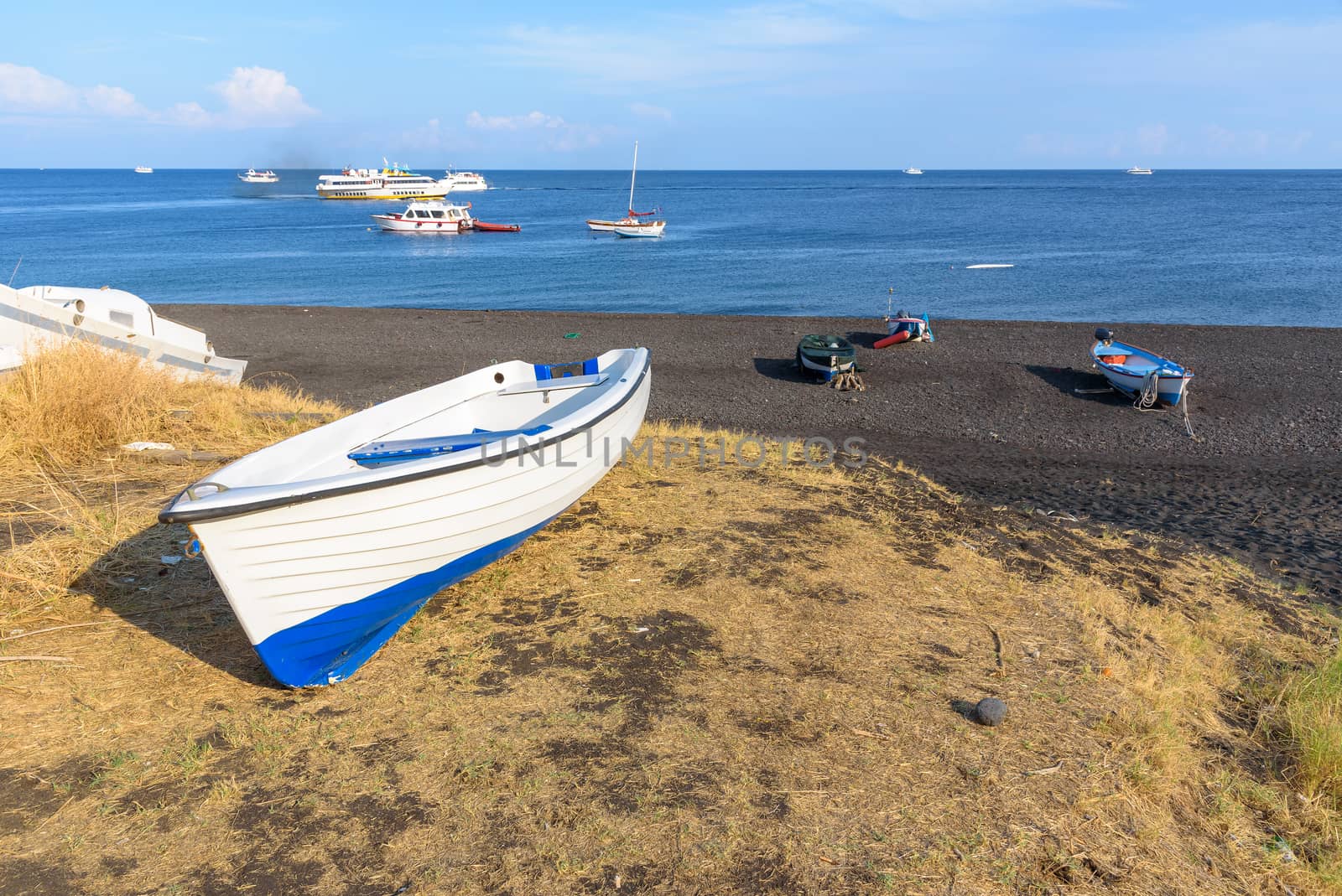 Boat on the black volcanic beach on Stromboli Island, Aeolian Islands, Italy