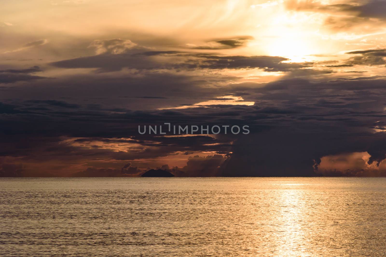 Dark clouds at sunset on the Tyrrhenian Sea with Stromboli vulcano in the background