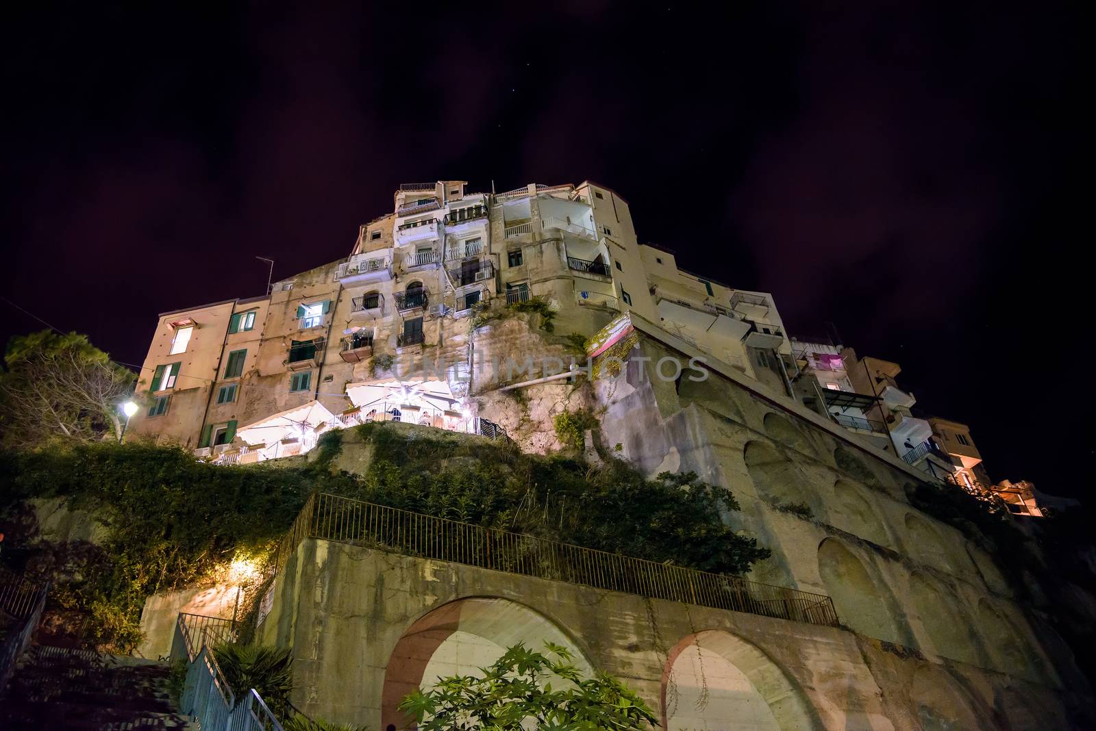 Buildings on a cliff in Tropea by night, Calabria, Italy