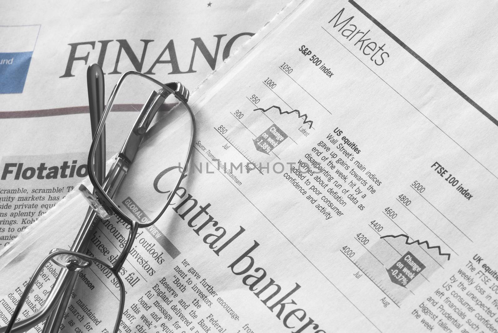 Glasses over positive financial charts. Financial market analysis