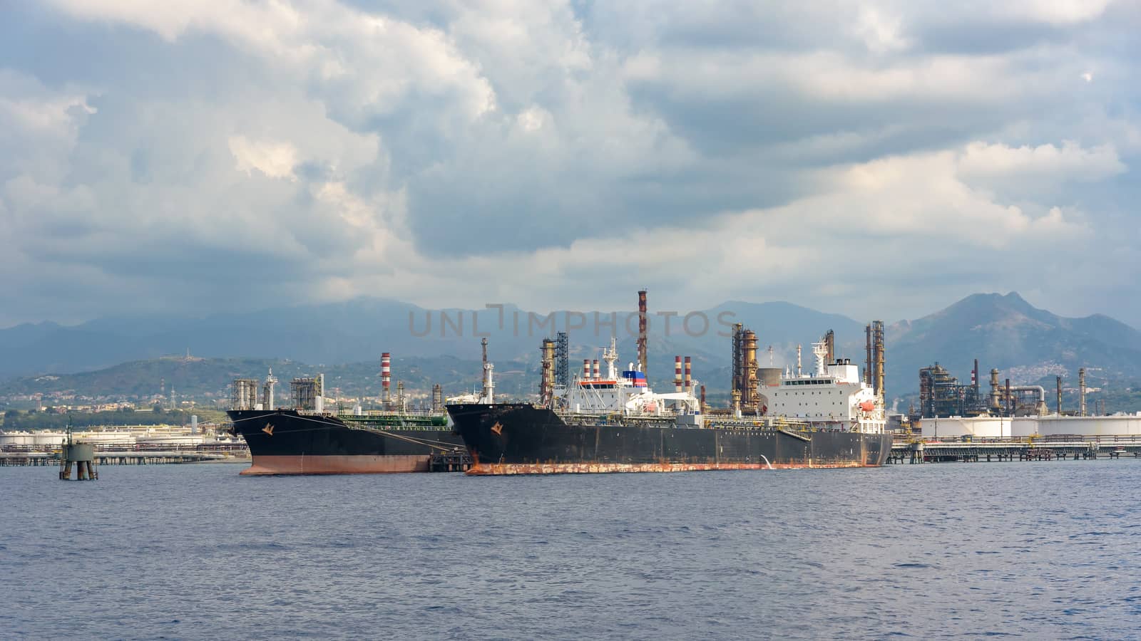 View of big ships in industrial zone in Milazzo on Sicily, Italy